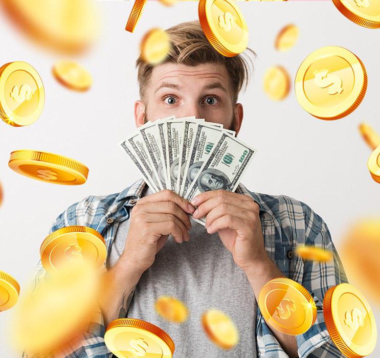 Male in chequered shirt holding fan of money with gold coins in background